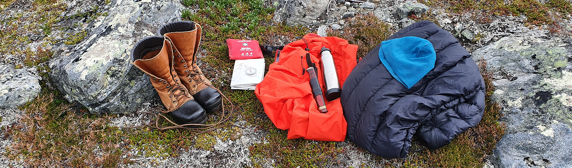 Friluftsutrustning som ligger upplagd på marken